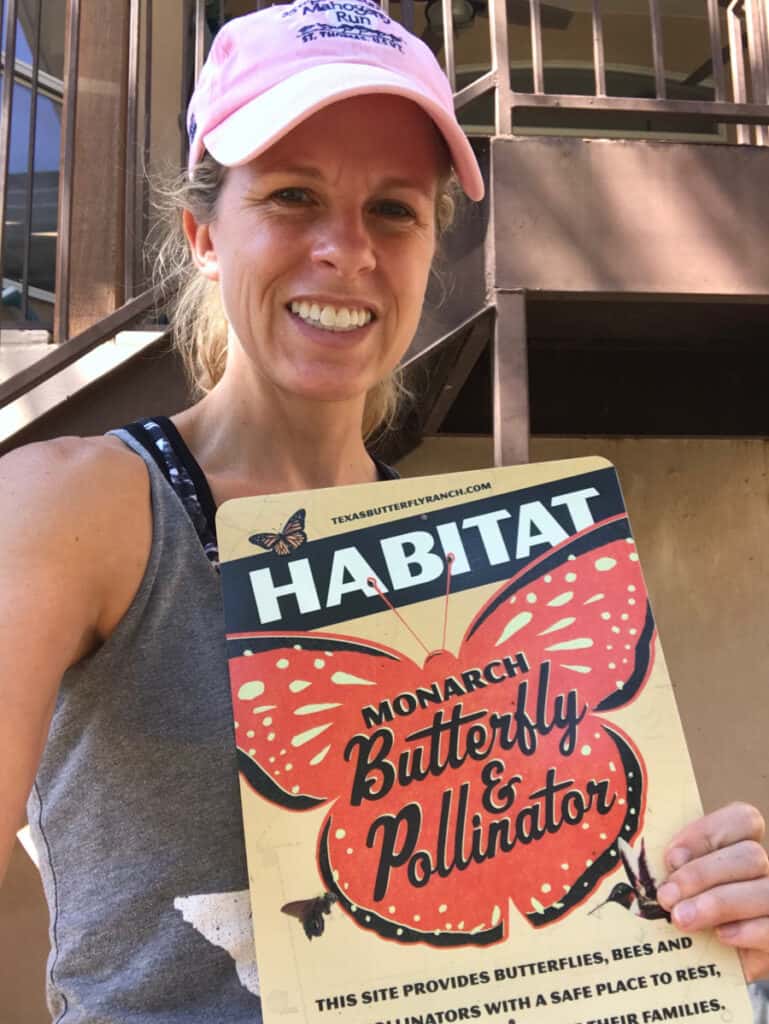 Native Backyards website founder holding butterfly habitat sign