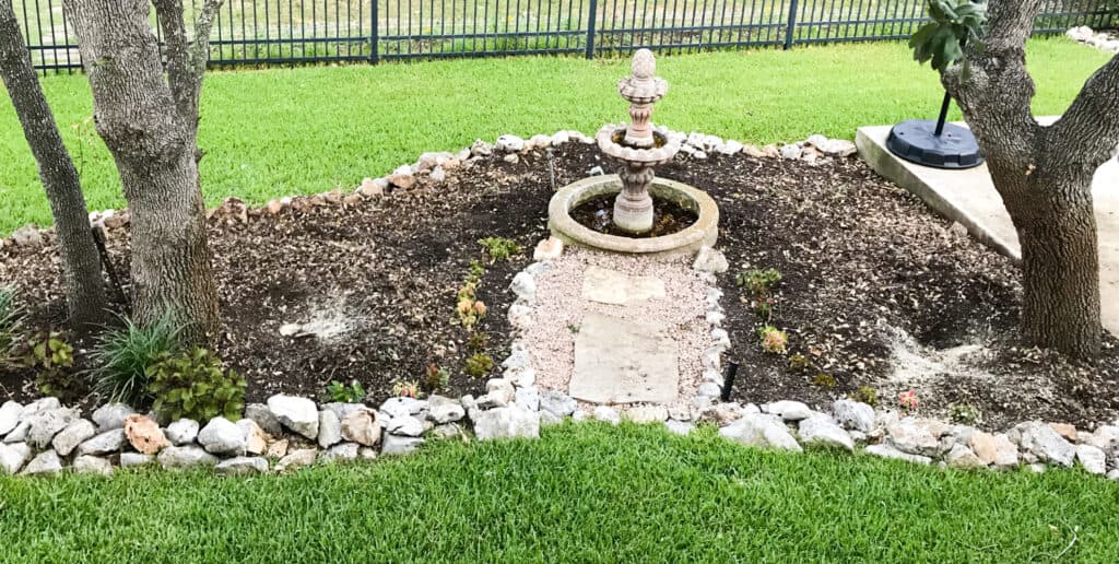 Landscaped area cleared for native plants.