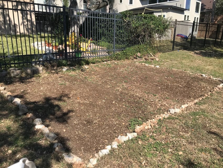 Bare soil prepped for native wildflower garden.